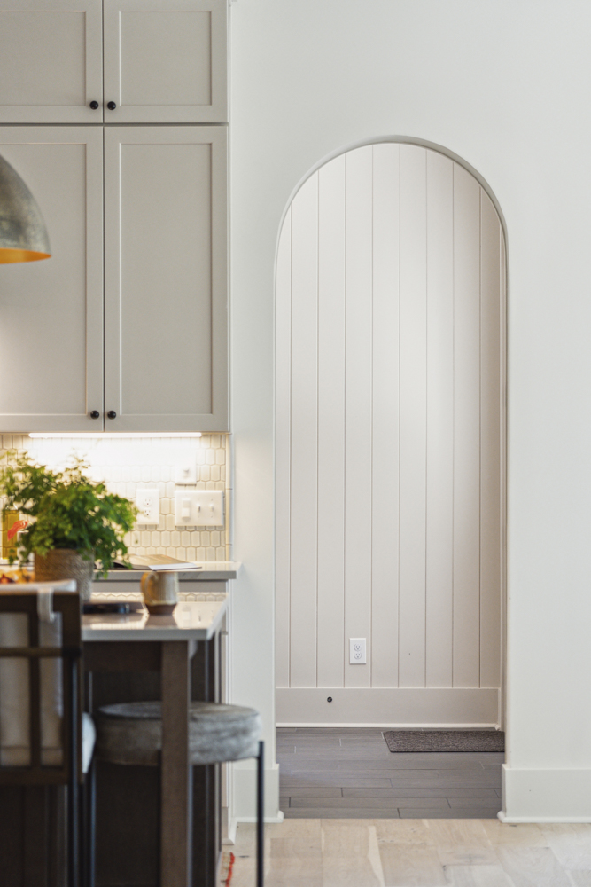 Kitchen with view to hallway with arched entryway