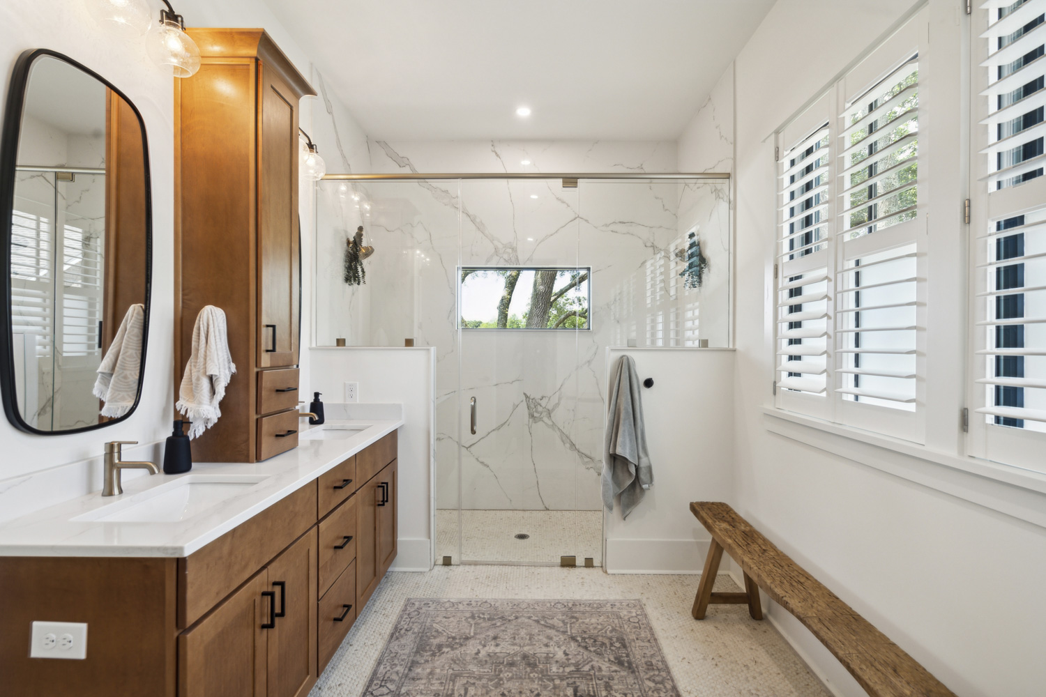 Custom bathroom with rounded corner mirrors at dual vanity